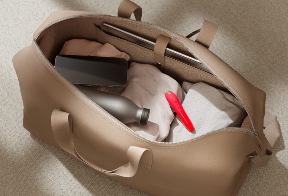 Red We-Vibe Tango X lipstick bullet vibrator in an open carry-on bag